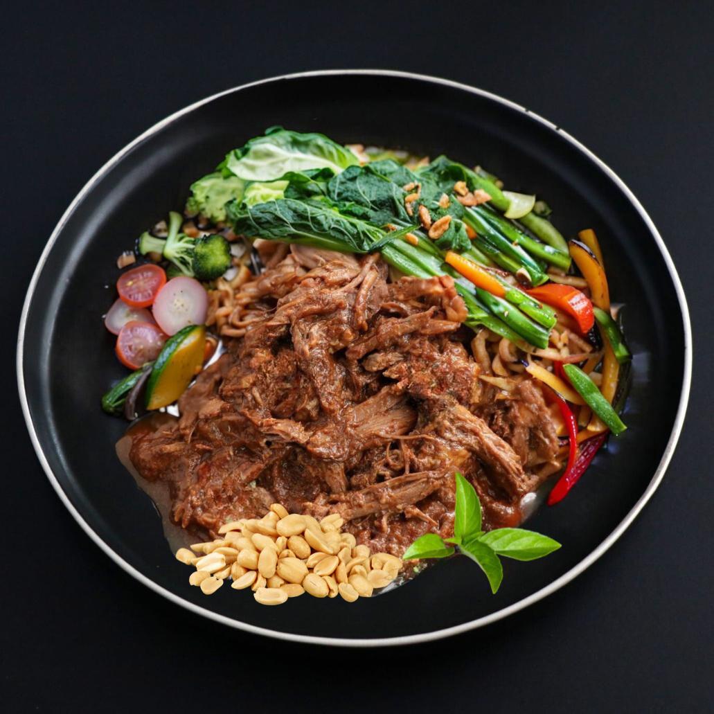 Juicy and tender Keto pulled beef under lucious red that curry sauce, topped with roasted peanuts and sided with assortment of oriental vegetables.