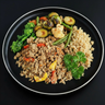 A plate of ground lean beef mixed with vegetables, served with bulgur and a side of green broccoli, brussel sprouts and green beans, garnished with parsley