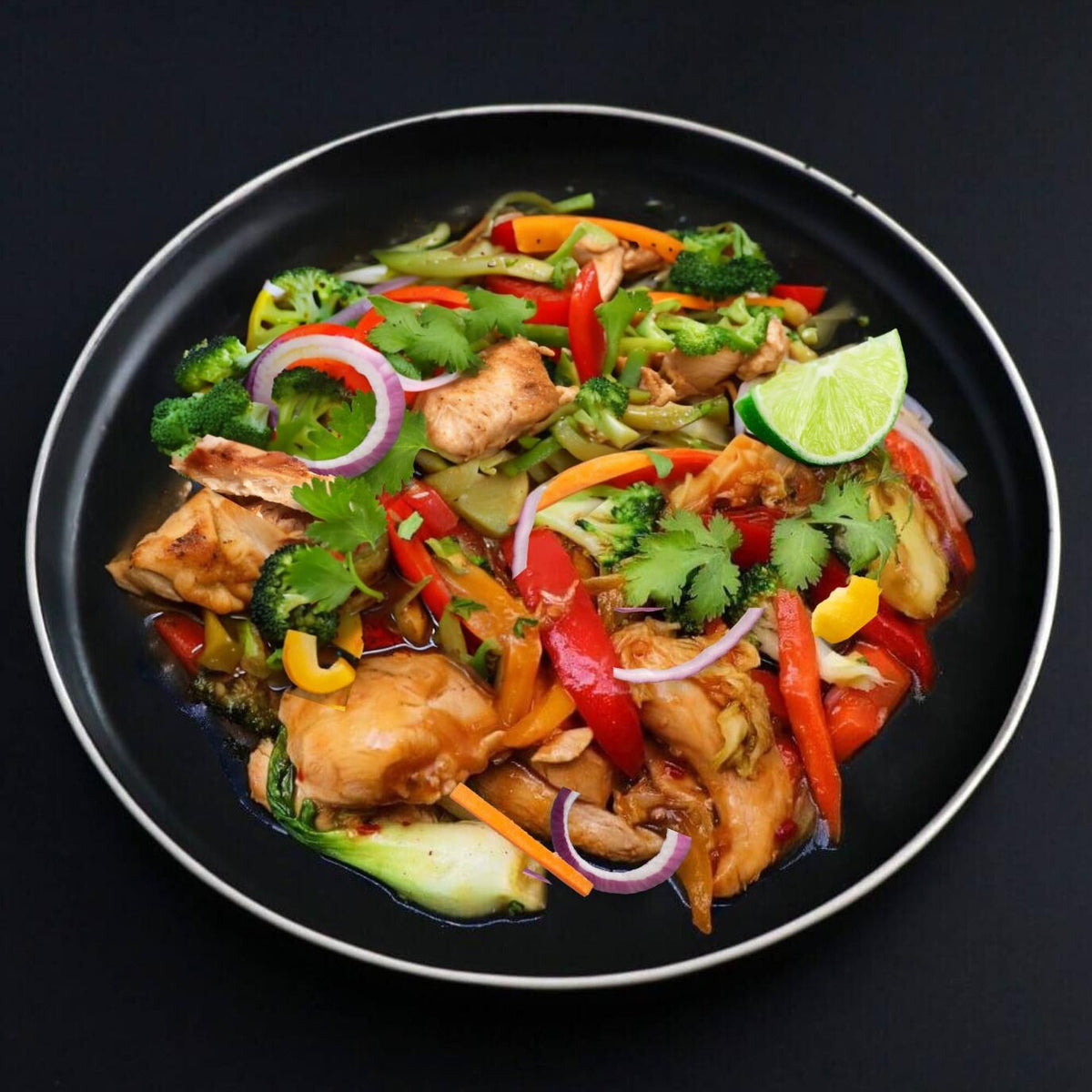 A plate of balanced chicken stir fry with crispy vegetables, including onions, peppers, and broccoli, garnished with a lime slice.