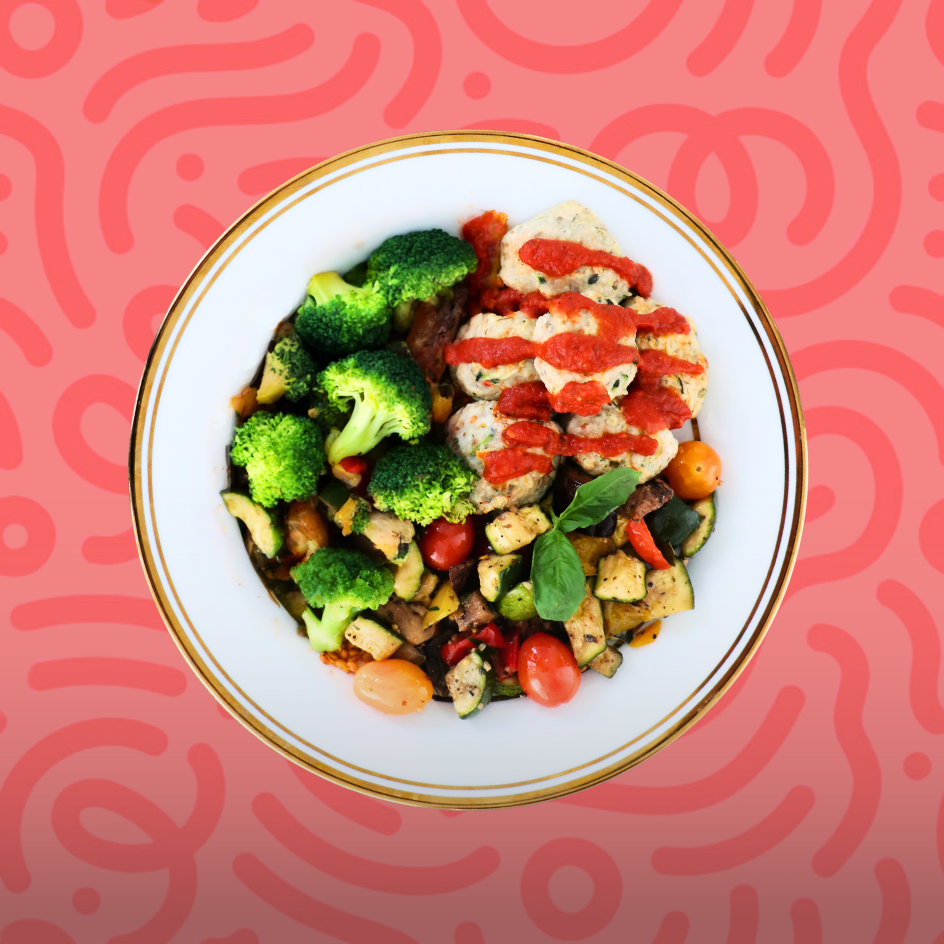Balanced portion-controlled meal of turkey meatballs with tomato sauce, roasted Mediterranean vegetables, and broccoli on a red background.