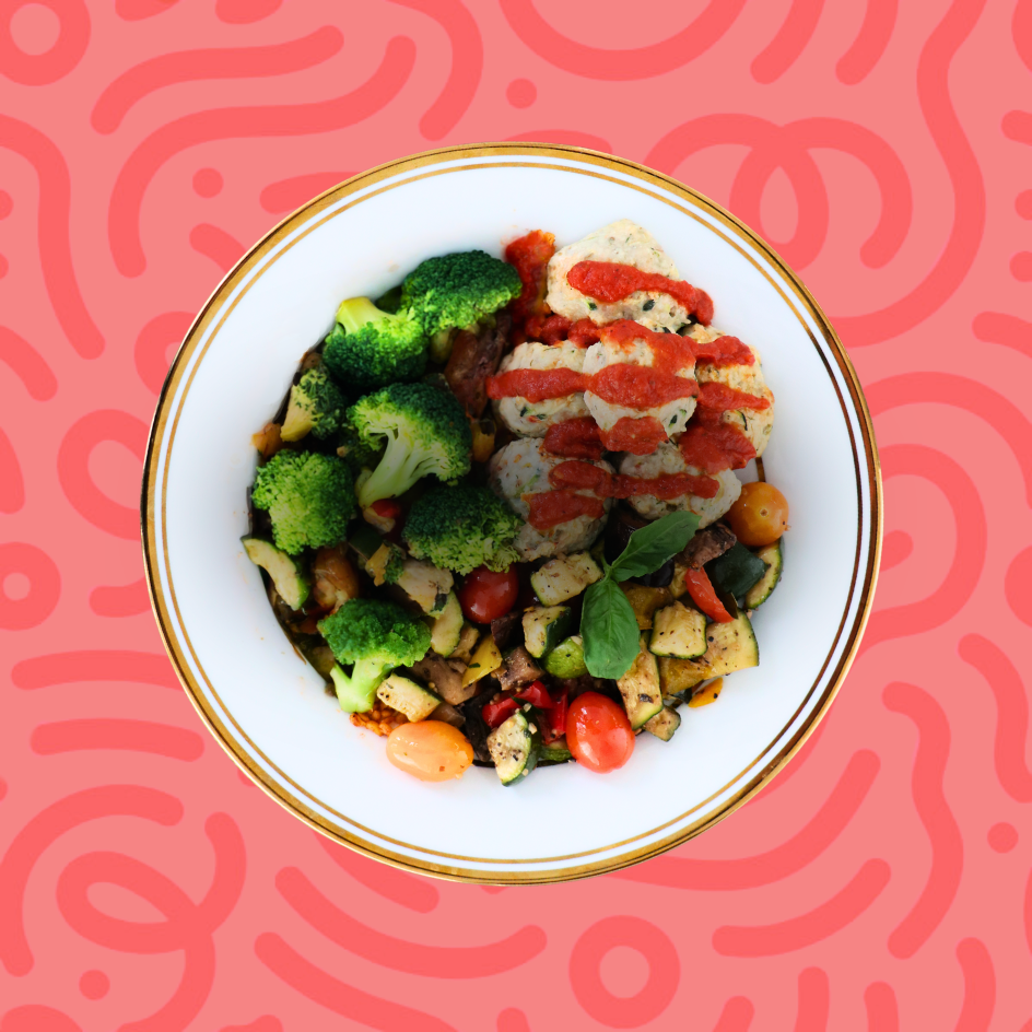 Balanced portion-controlled meal of turkey meatballs with tomato sauce, roasted Mediterranean vegetables, and broccoli on a red background.