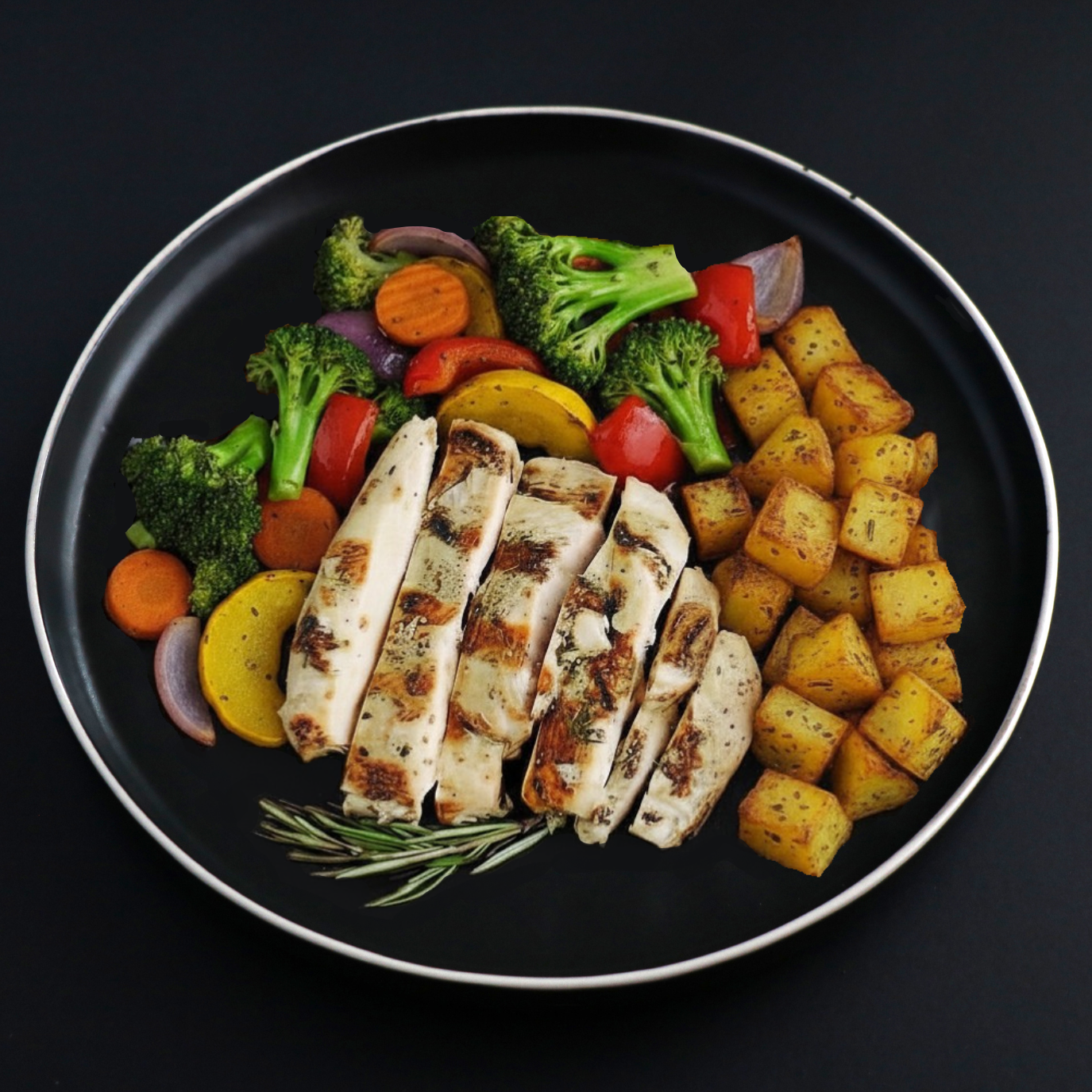 A black plate with a silver rim containing sliced grilled chicken breast, roasted golden-brown potatoes, broccoli, carrots, red bell peppers, yellow squash, and red onion on a dark background.