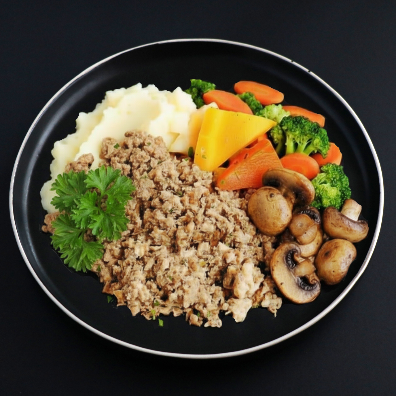 Lean ground Turkey with a side of mashed potato and assorted veggies included carrots, mushroom and broccoli on a dark plate