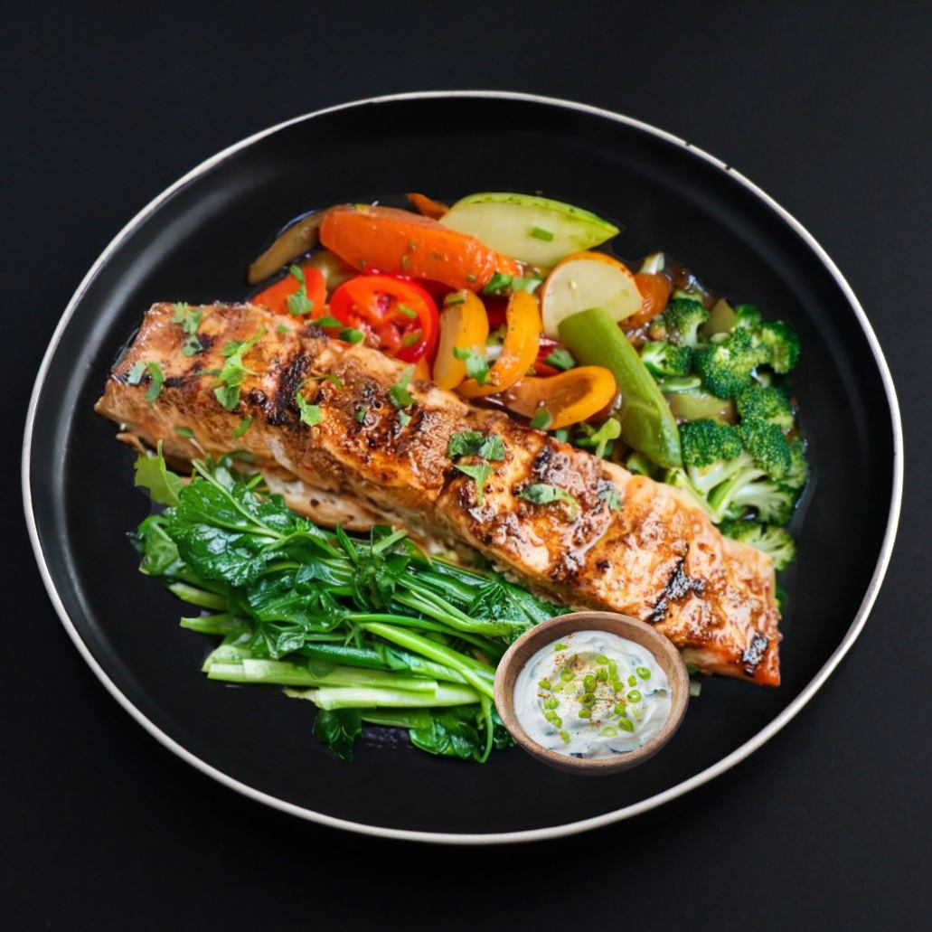 Juicy and flaky slice of Keto Tandoori salmon complemented with homemade raita and assorted seasonal vegetables.