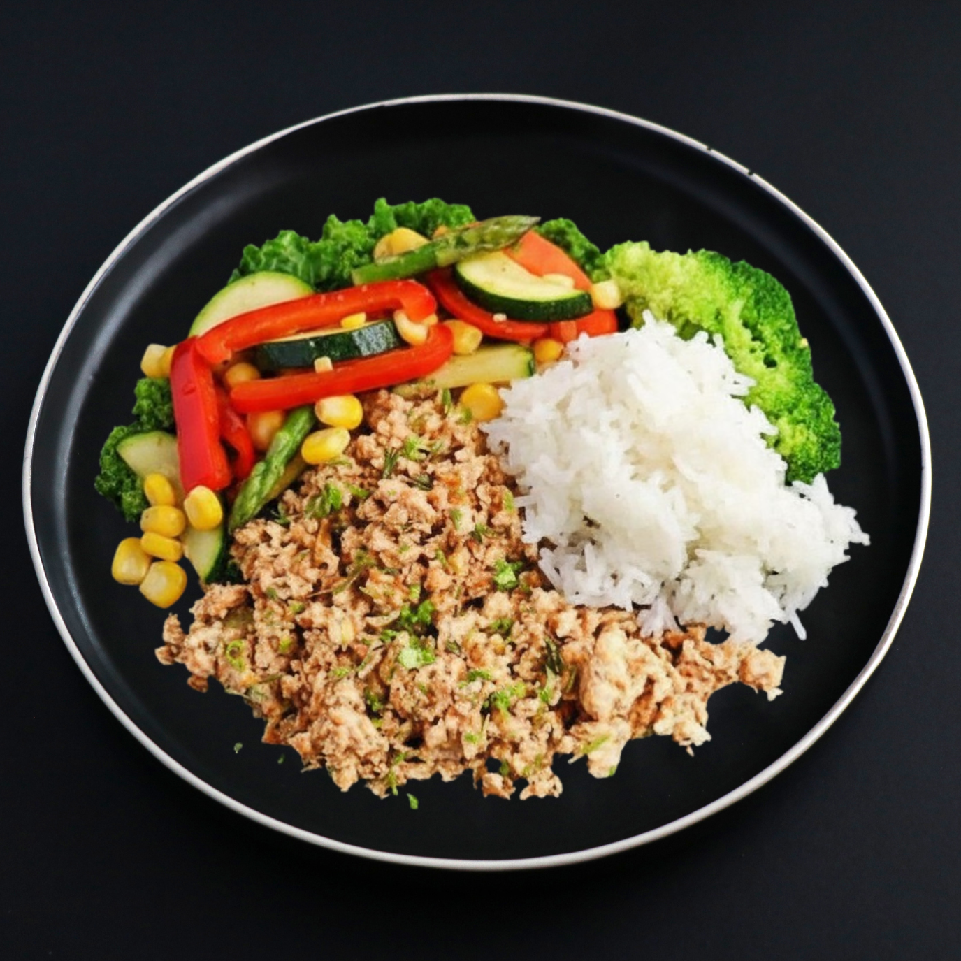 A plate of lean ground turkey with jasmine rice and a variety of vegetables on a dark background.