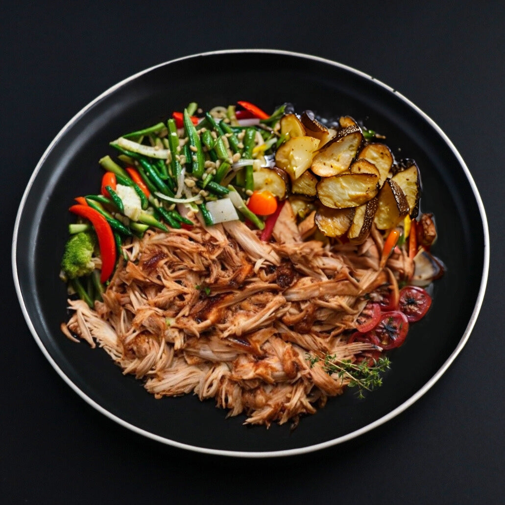 Juicy pulled gourmet chicken platter that comes with a side roasted potato and assortment of veggies.