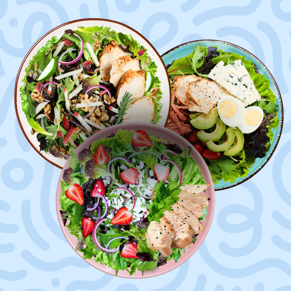 Salad variety featuring a harvest chicken salad with apples, a healthy Cobb salad with avocado and egg, and a strawberry feta chicken salad on a blue background.
